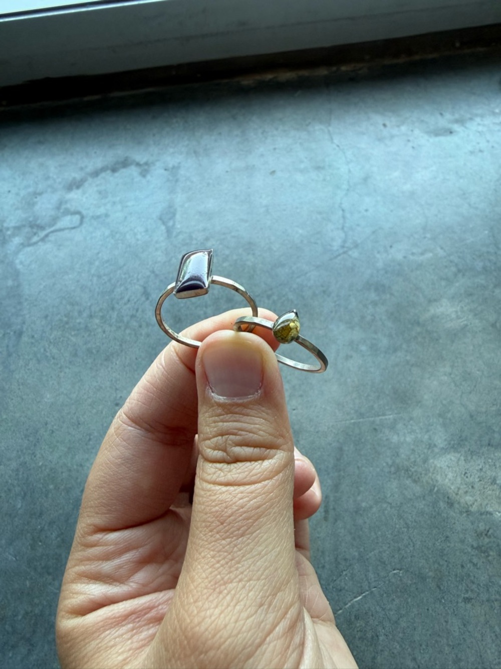 Two silver with stones rings